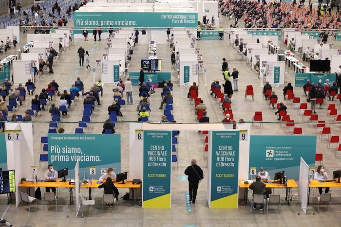 People wait to be vaccinated against Covid-19 disease at the vaccination hub set up at the Brescia Fair, in Brescia, northern Italy, 29 April 2021.
